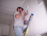 Tech Installing Alarm Panel for security in st.charles county